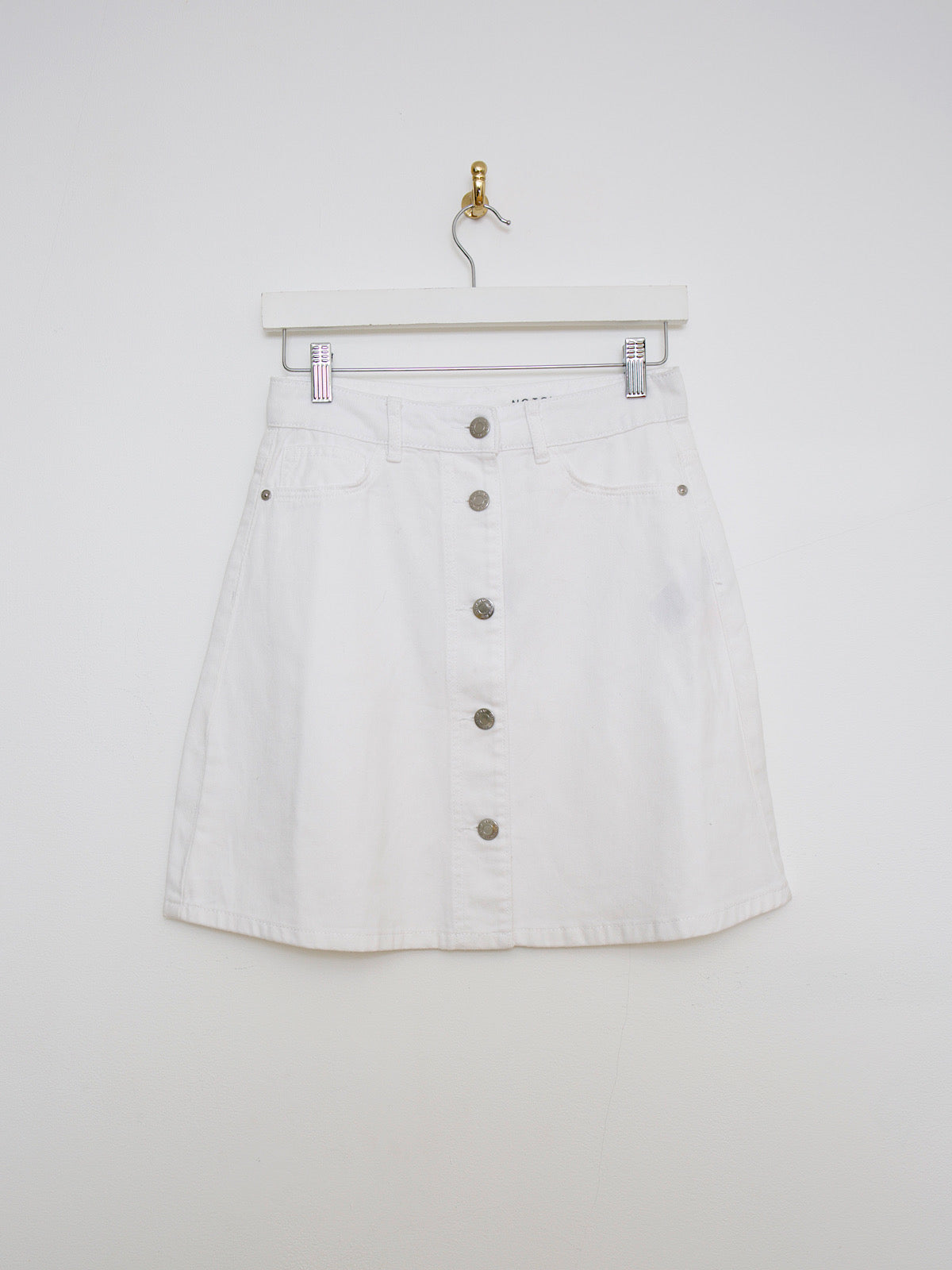 White denim mini skirt buttoned up