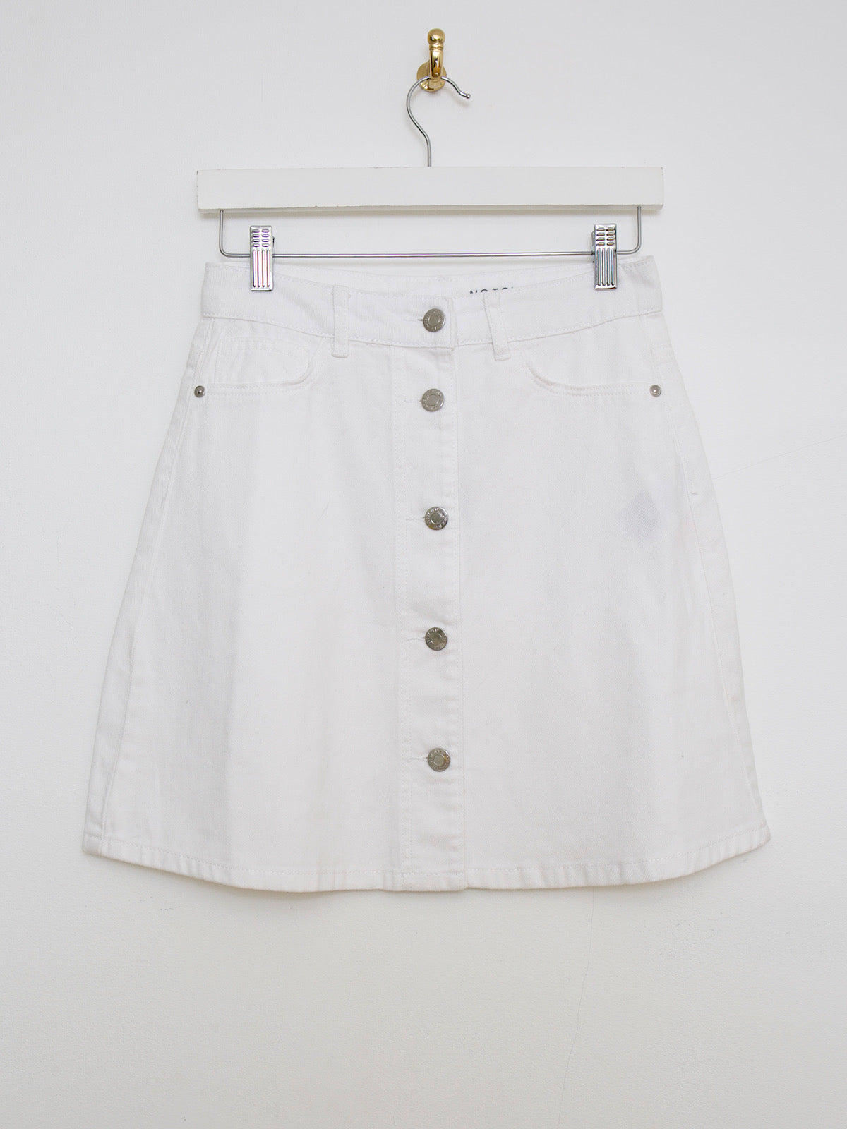 White denim mini skirt buttoned up