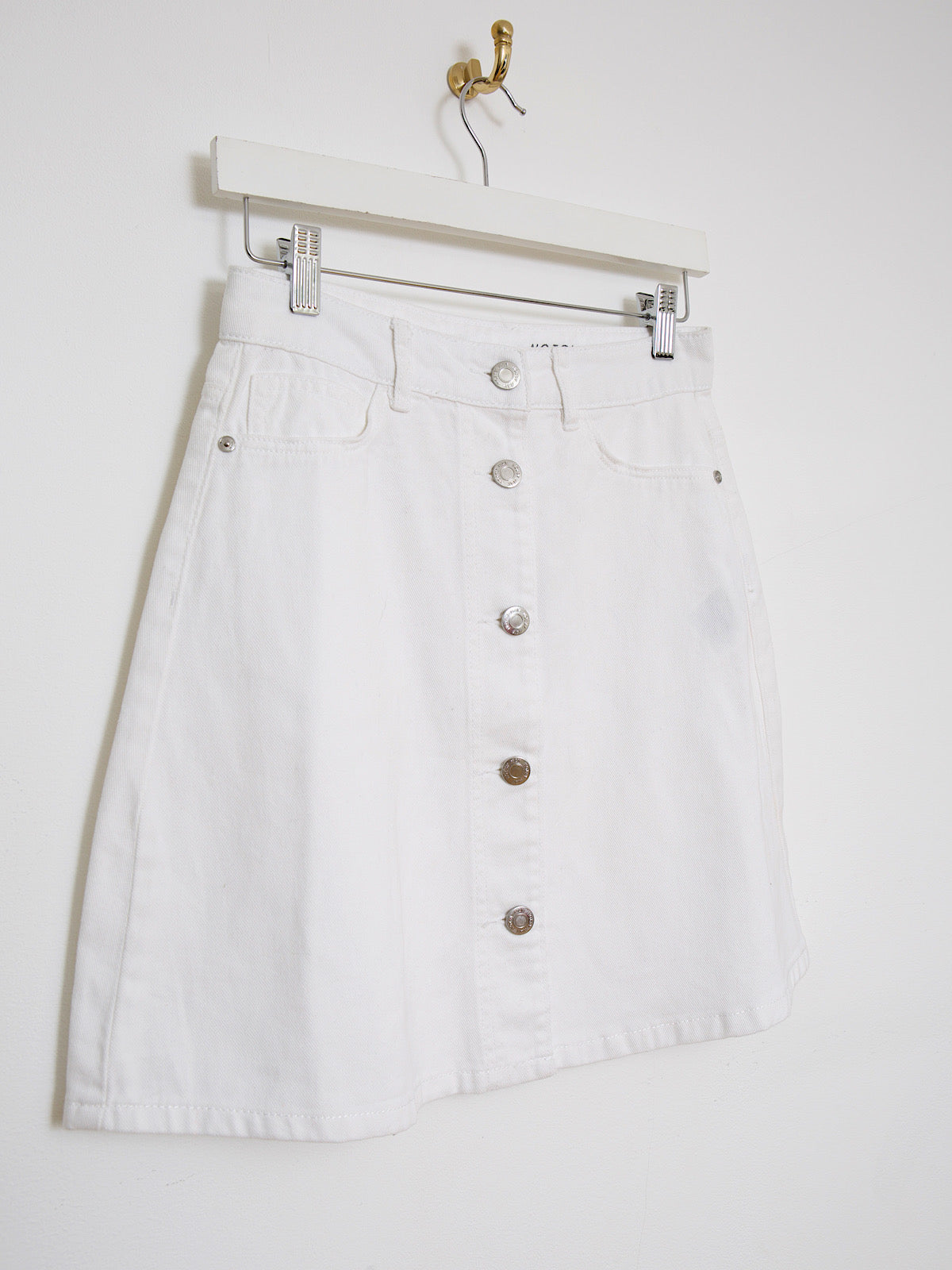 White denim mini skirt buttoned up