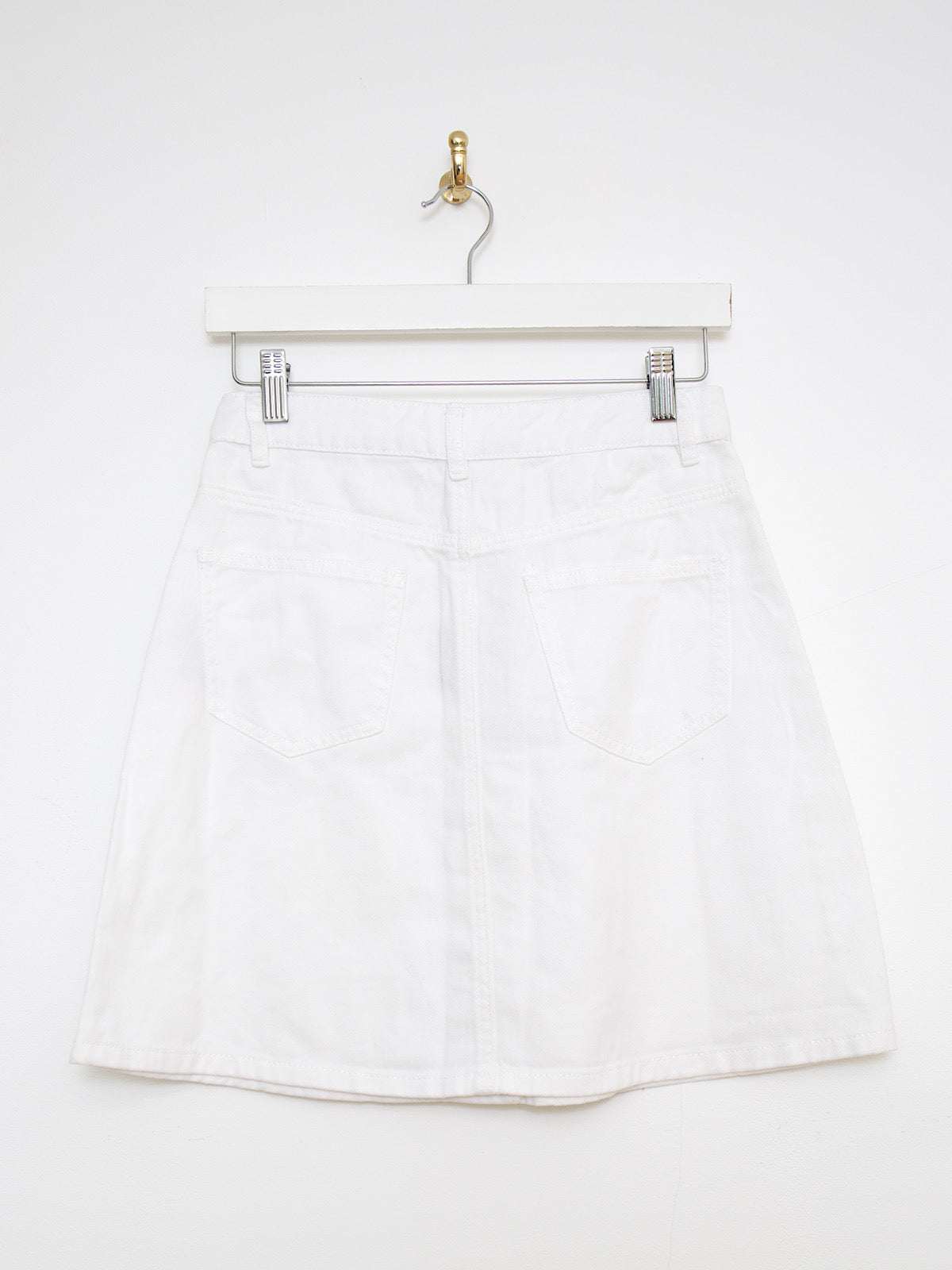 White denim mini skirt buttoned up